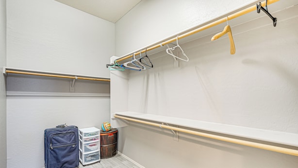 A room with a wooden ballet barre, a blue suitcase, and storage bins. - Hot Tub & On-site Hiking: Phoenix Retreat! (Phoenix)