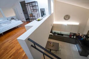 A modern apartment with a kitchen, dining area, and a bedroom. - Relax with the whole family in this peaceful accommodation nestled in the countryside  (Toscana)