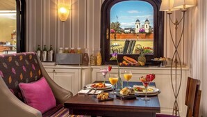 A dining area with a table set for breakfast, a view of a church, and striped wallpaper. - The Inn at the Spanish Steps Exclusive Collection - Roberto Di Rienzo (Rome)