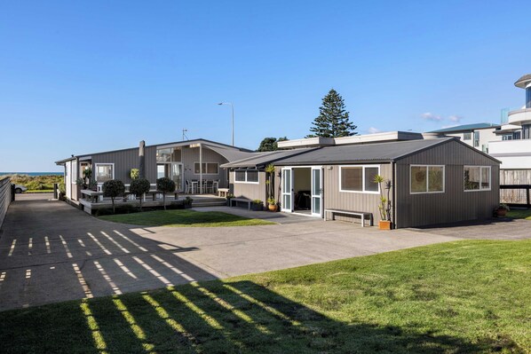 A modern residential complex with multiple houses, a paved driveway, and well-maintained lawns.