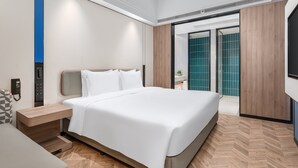A modern hotel room with a large bed, a bedside table, a phone, and a view of the bathroom. - Holiday Inn Express Chengdu Shuangliu Airport (Chengdu)