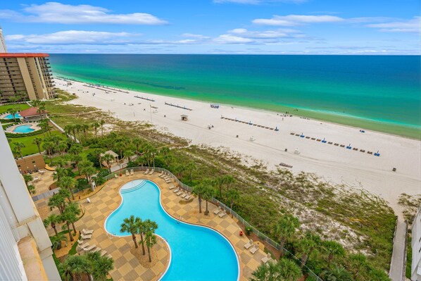 A resort with a pool, beach, and ocean view.