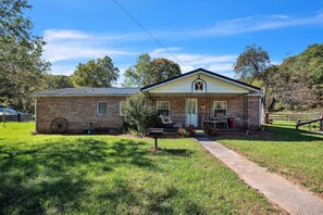 A two-story brick building with a white facade and a prominent 'Y' logo on the front.
