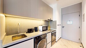 Fridge, microwave, stovetop, toaster - Mag Eye - Elegant Studio Apartment in Meydan (Meydan)