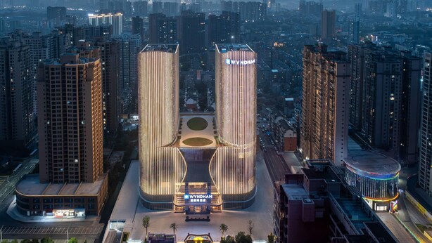 A modern high-rise building with a distinctive central atrium and a prominent 'WYNDHAM' sign. - Wyndham Huaihua South (Huaihua)