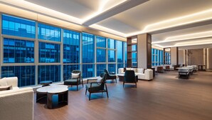 A spacious, modern lounge area with large windows, comfortable seating, and a clean, contemporary design. - Wyndham Huaihua South (Huaihua)