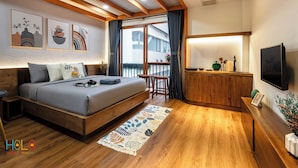 A modern bedroom with a bed, wooden headboard, and a view of the outside.