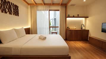 A hotel room with a large bed, a wooden headboard, a desk with a mirror, and a view of the outdoors.