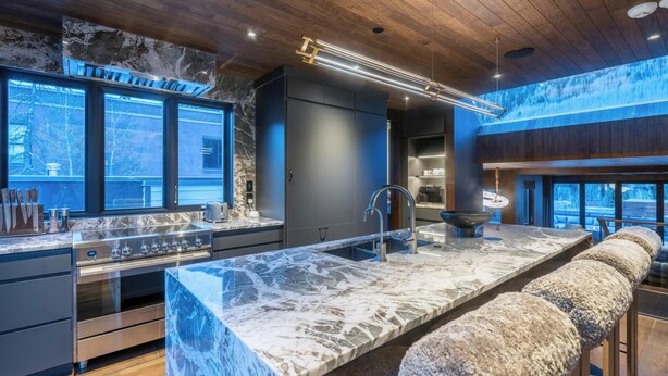A modern kitchen with marble countertops, stainless steel appliances, and a large island. - New Penthouse, Center of Town, Sauna, Deck, Fireplace, Views, Parking, Ski Room (Telluride)