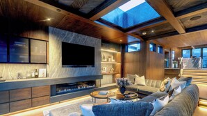 A modern living room with a flat-screen TV, a fireplace, and a sofa set. - New Penthouse, Center of Town, Sauna, Deck, Fireplace, Views, Parking, Ski Room (Telluride)