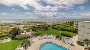 A resort with a pool, lounge chairs, and a view of the beach and ocean. - Beach Club 203 aka "Beach Walk" 2br/2ba Oceanfront Complex (Saint Simons Island)