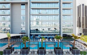 Outdoor pool - Aya - Elegant 1BR Retreat In The Heart Of JVC (Dubai)