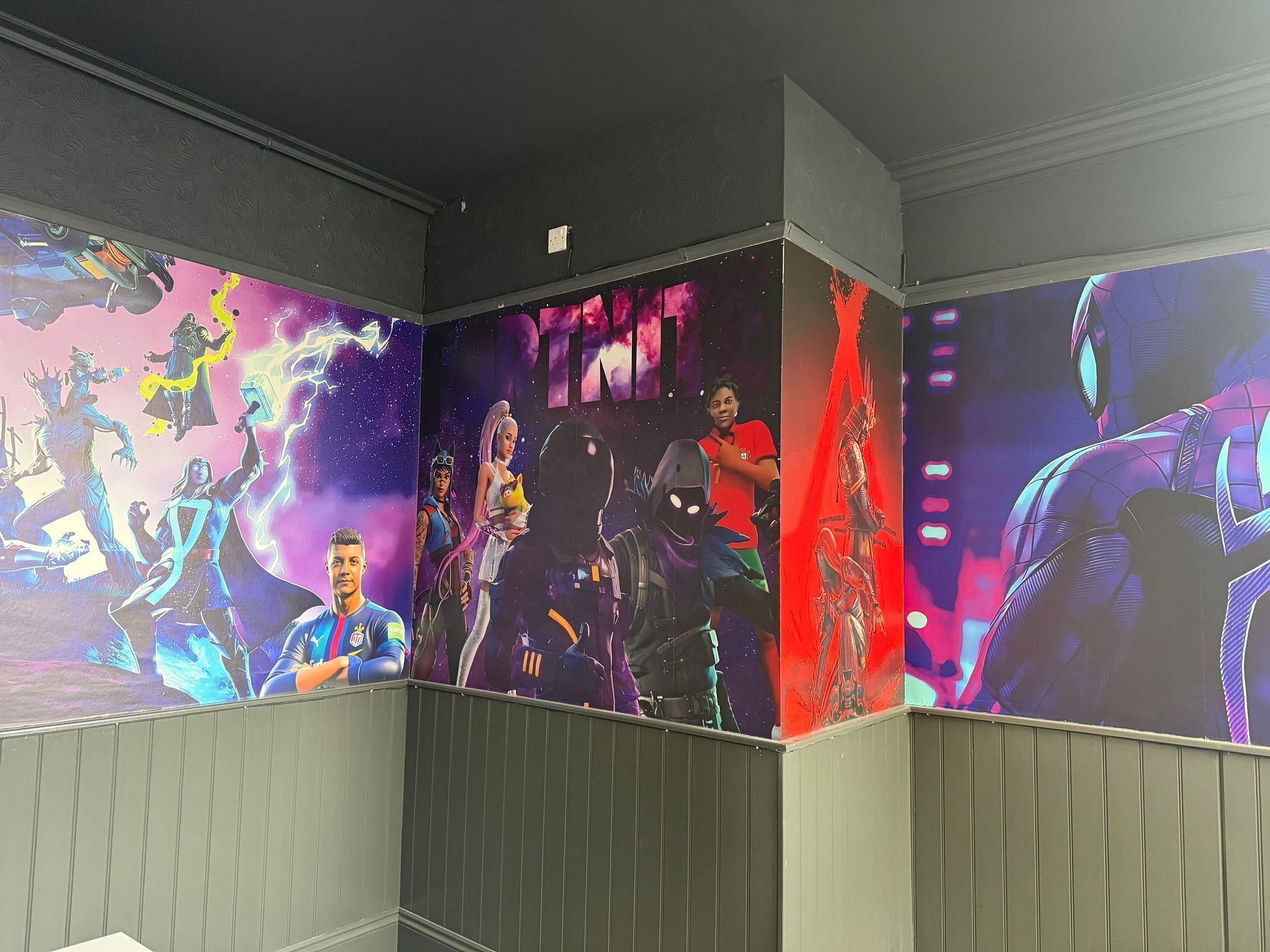 A corridor with walls decorated with vibrant, colorful murals of various characters and scenes.