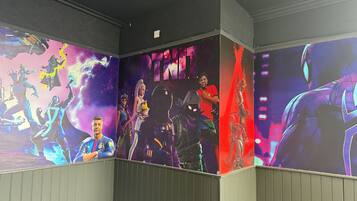 A corridor with walls decorated with vibrant, colorful murals of various characters and scenes.