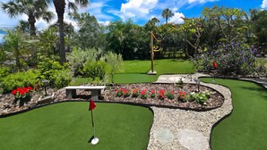 A miniature golf course with a putting green, sand traps, and a flagstick. - Walk to Siesta Key Beach! (Siesta Key)
