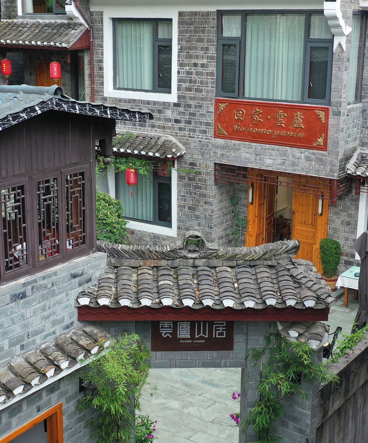 A traditional Chinese courtyard with a sign for 'Cloud Lodge'.