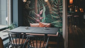 A dining area with a table, chairs, and a mural of a forest scene. - 4 Star Holiday Home in Hisings Backa (Hisings Backa)