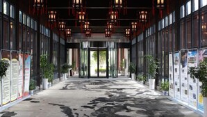 A corridor with a patterned floor, glass doors, and red hanging lights.