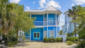 A two-story building with a blue exterior, white railings, and a balcony. - 30A Beach House - Seagrove Escape by PHG (Santa Rosa Beach)
