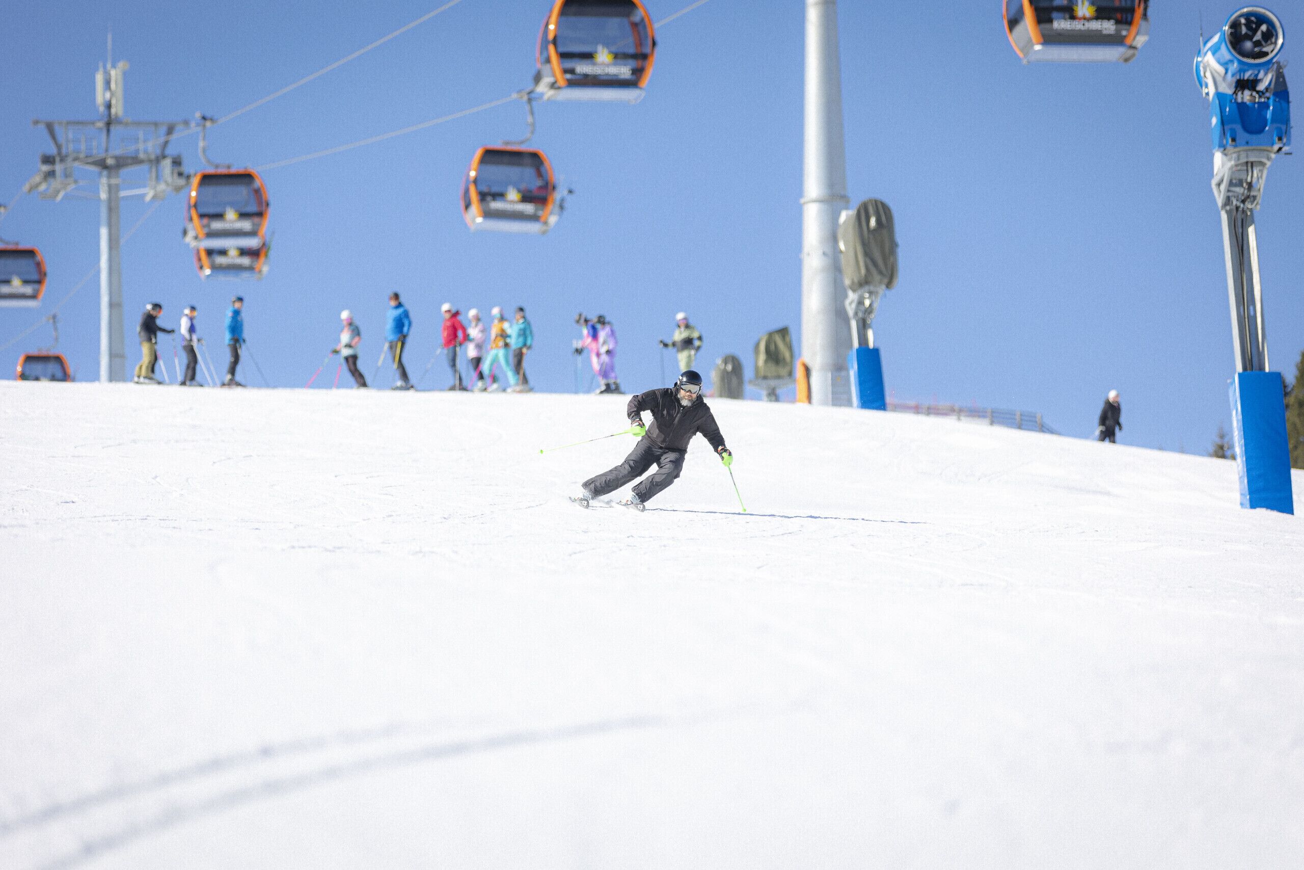 A ski slope with skiers and ski lifts.