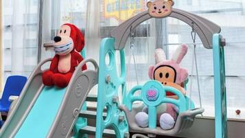 A children's play area with a slide and a hanging seat.