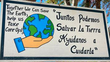 A sign with a hand holding a globe, promoting environmental conservation.