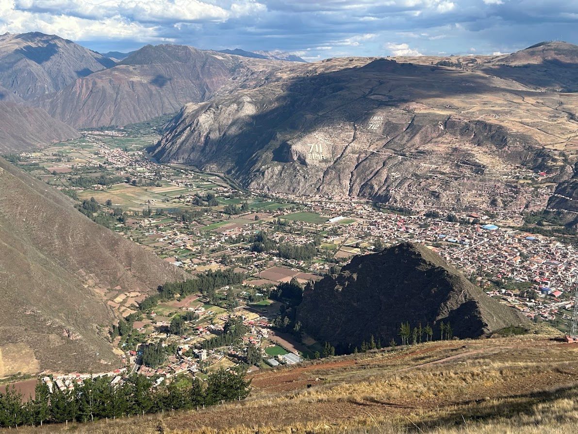 A mountainous landscape with a valley and a town.