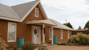 A single-story house with a gabled roof, a front porch, and a front door.