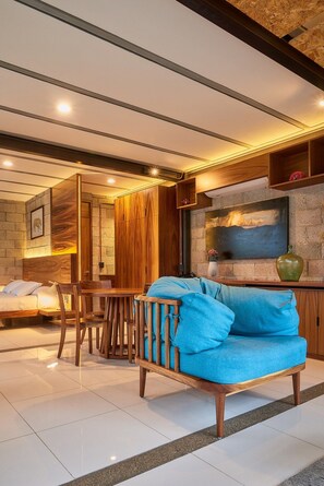 A modern interior with a sofa, wooden furniture, and a painting on the wall.