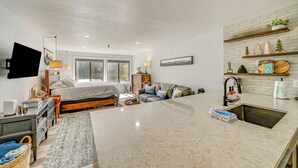 A modern kitchen with a large island, a built-in sink, and a breakfast bar. - Ski Retreat w/ Hot Tub Access in Winter Park! (Winter Park)