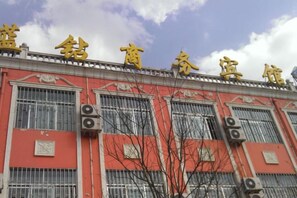 Un bâtiment doté de grandes fenêtres et d’une façade rouge.
