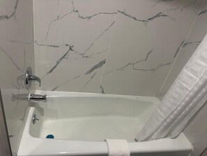 Bathtub, towels, soap, shampoo