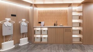 A modern bathroom with wooden paneling, a sink, and storage cabinets. - Starway Hotel (Linhai Intime City) (Linhai)