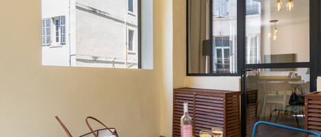 A balcony with two chairs, a small table, and a handbag.