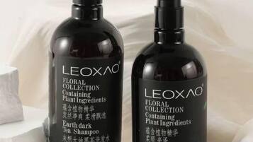 Two bottles of LEOXAO FLORAL COLLECTION Plant Ingredients Earth dark Tea Shampoo.