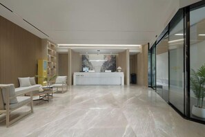 A hotel lobby with a reception desk, seating area, and a large window. - Kairuiting Hotel (Baguocheng Chongqing West Railway Station) (Chongqing)