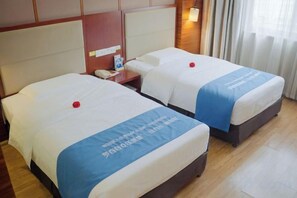 Two beds with matching headboards and footboards, a bedside table with a phone, and a window with curtains. - Shanghecheng Hotel (Feixi)