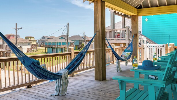A wooden deck with turquoise chairs and a hammock. - Hot Tub & Direct Beach Access: Walk, Drive or Cart (Bolivar Peninsula)
