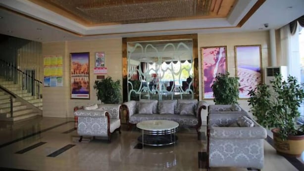 A lobby with a staircase, a sofa set, a coffee table, and potted plants. - Inner Mongolia Too Western Coal Taixi Logistics Information (Alxa Left Banner)