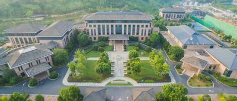 An aerial view of a campus with multiple buildings, green lawns, and a central courtyard.