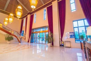 A spacious lobby with a staircase, large windows, and a reception desk. - Qing He Hotel (Hangzhou)