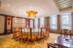 A conference room with a round table, chairs, and a chandelier. - Qing He Hotel (Hangzhou)