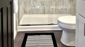 Shower, hair dryer, towels, toilet paper