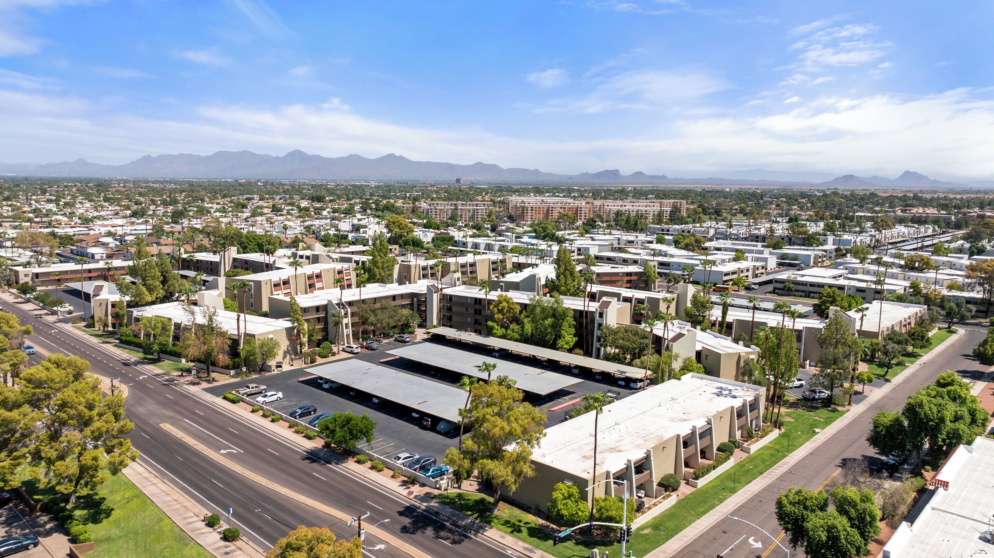 A large, modern building complex with multiple parking lots and a central courtyard.