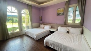 A bedroom with two beds, large windows, and a view of greenery. - Isa Butterfly Kids B&B (Yilan)