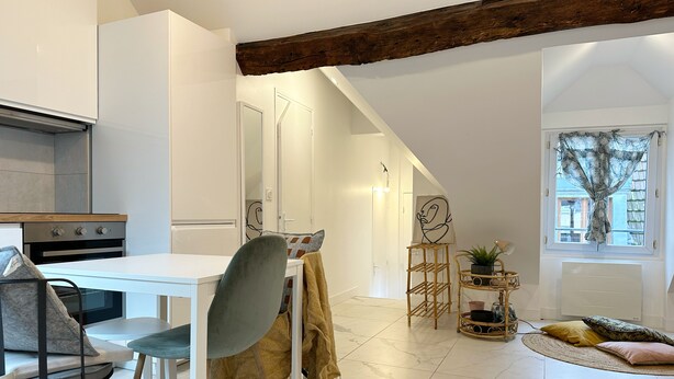 A modern kitchen with white cabinetry, a built-in oven, and a dining area with a white table and chairs. - Lovely Rooftop designed Apt 200m to Panthéon  (Paris)