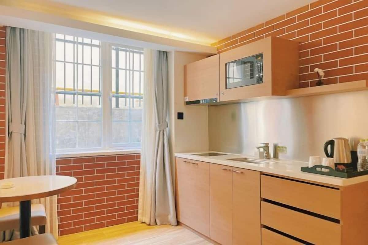 A compact kitchen with a window, a sink, and a countertop.
