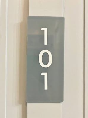 A door with a number plate displaying the number 101. - Double One Coliving and Coworking Hostel (Makati)