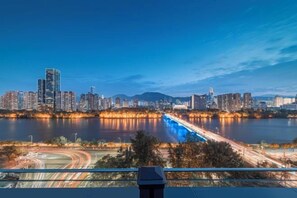 A city skyline with high-rise buildings, a river, and a bridge. - Starway Hotel (Lanzhou Railway Station) (Lanzhou)