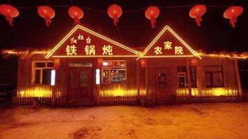 A building with illuminated signage indicating a restaurant and a laundry service.